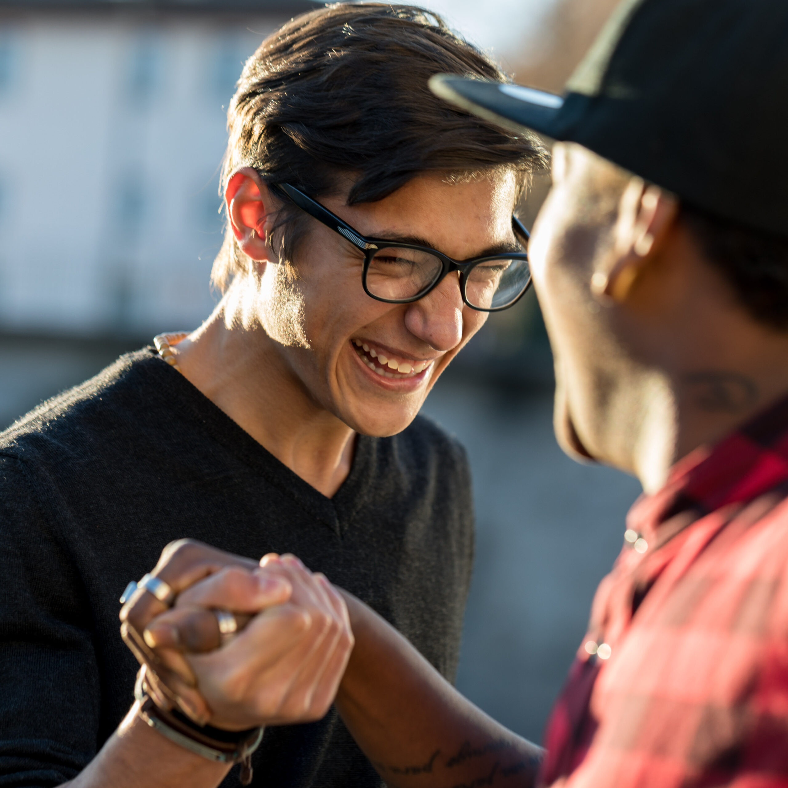 good friends joking about their secret handshake